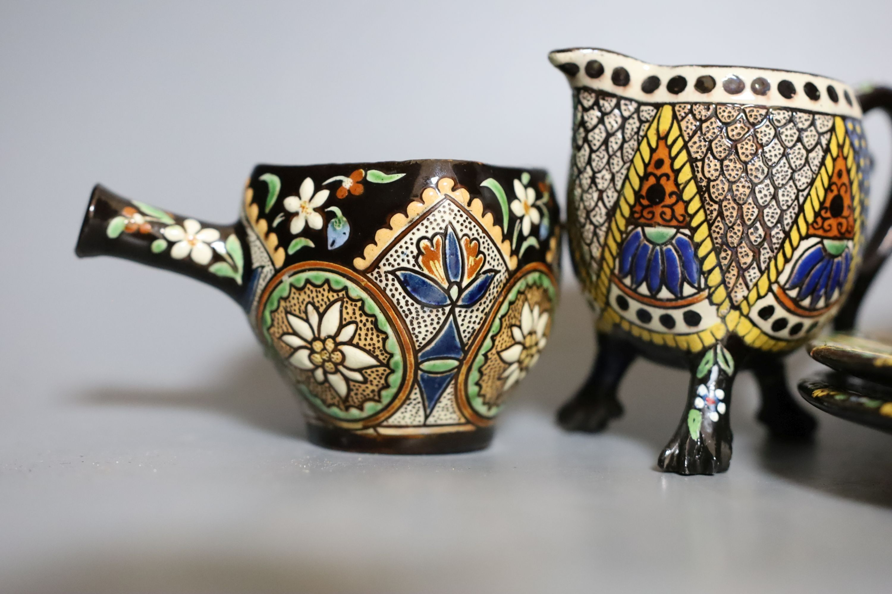 A Swiss Thoune treacle glazed incised pottery tea set, with coloured decoration (8)